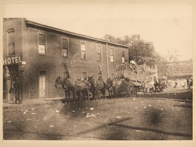 Six Mules Pulling Wagon Filled with Bales of Cotton on Unidentified Street by William G. Swekosky